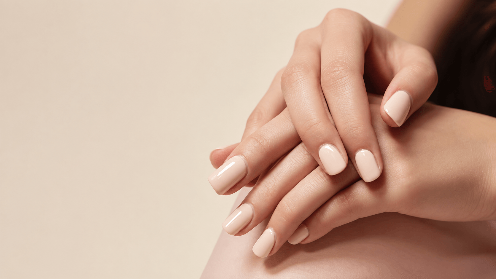 Elegant ivory manicure on a warm beige background